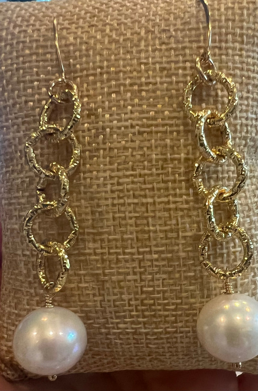Large pearl dangles from large chain earrings